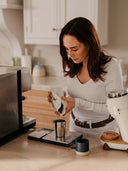 A contemporary stoneware tasting mug beside an espresso machine