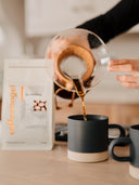 Coffee poured from a Chemex straight into a contemporary stoneware mug