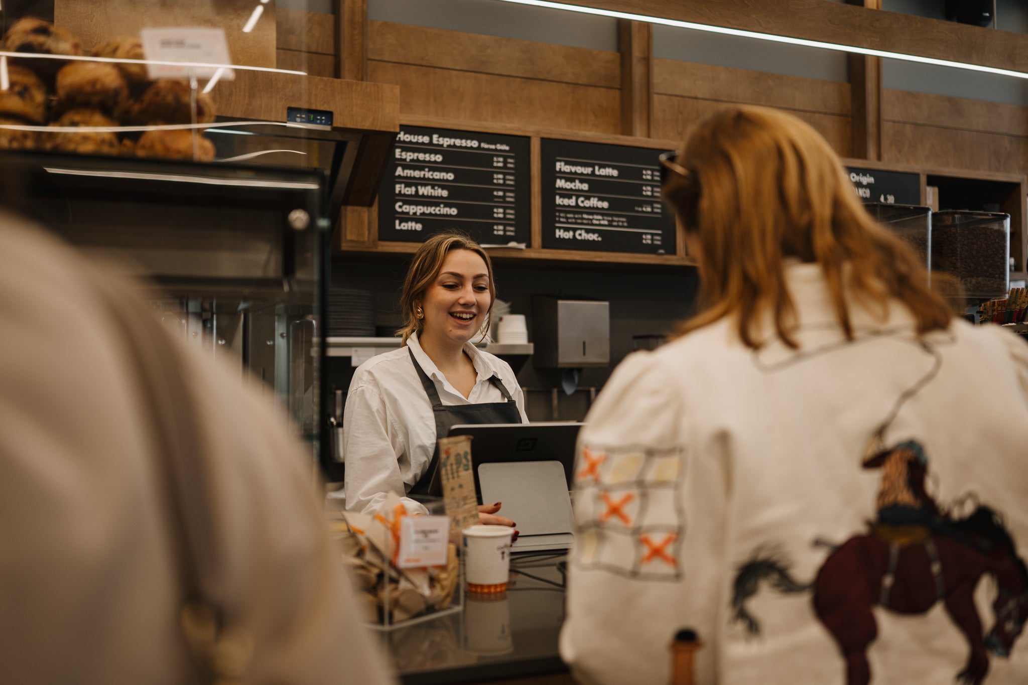 A Coffeeangel barista serving a customer at the counter