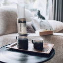 An AeroPress brewing straight into a hand-thrown stoneware mug